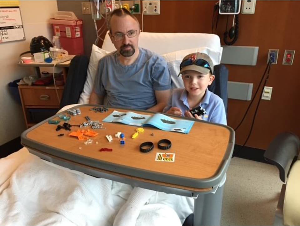 Brian standing at Spaulding Rehabilitation Hospital smiling during recovery